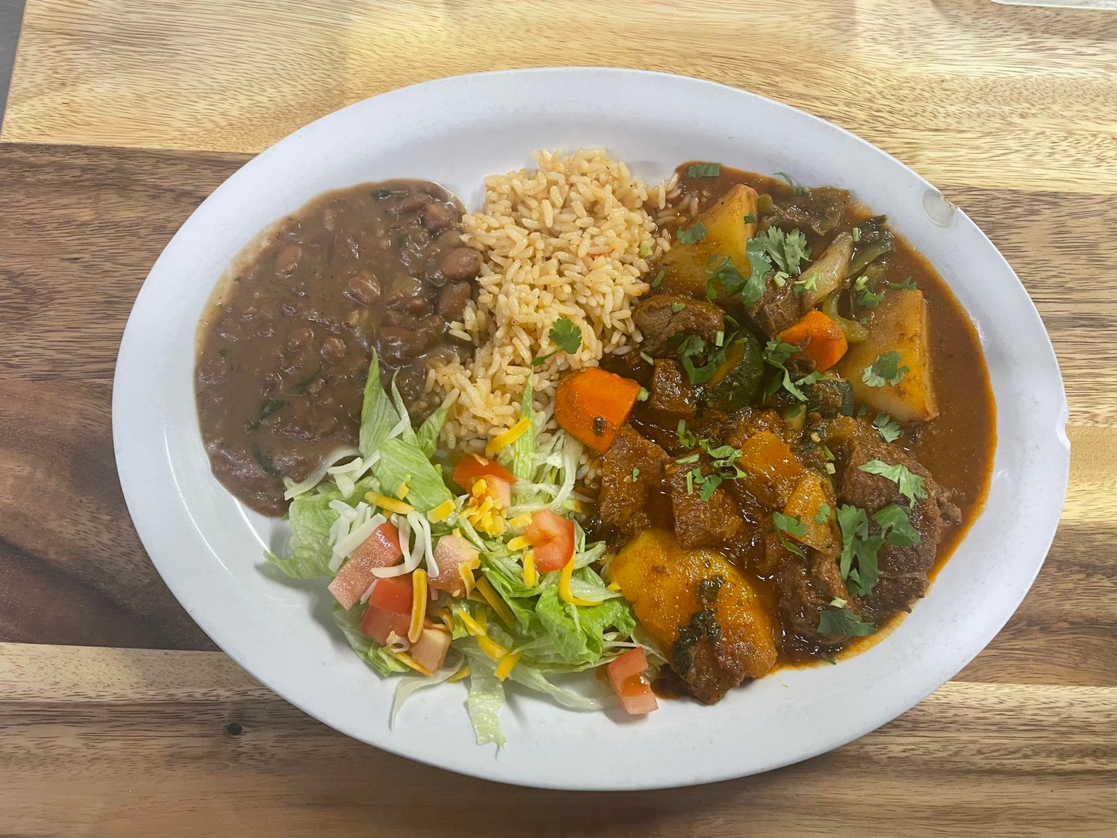 Carne guisada served with rice, beans, and salad at Anita's Tex-Mex