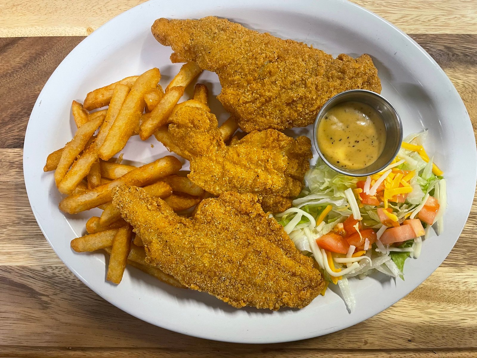 Fried catfish dinner with French fries and salad at Anita's Tex-Mex